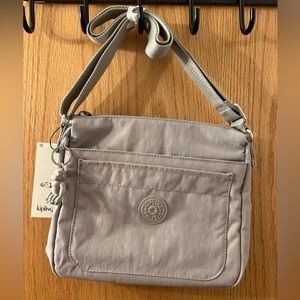 This is a gray purse that measures 10x9